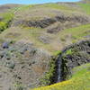 Percolated water creates a small waterfall in front of an old ranching fence at the top of the ridge.