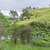 The green hills and blue waters of the Waihou River.