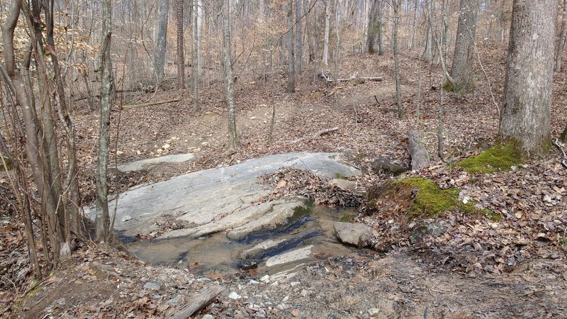 Natural rock surface, creek crossing.