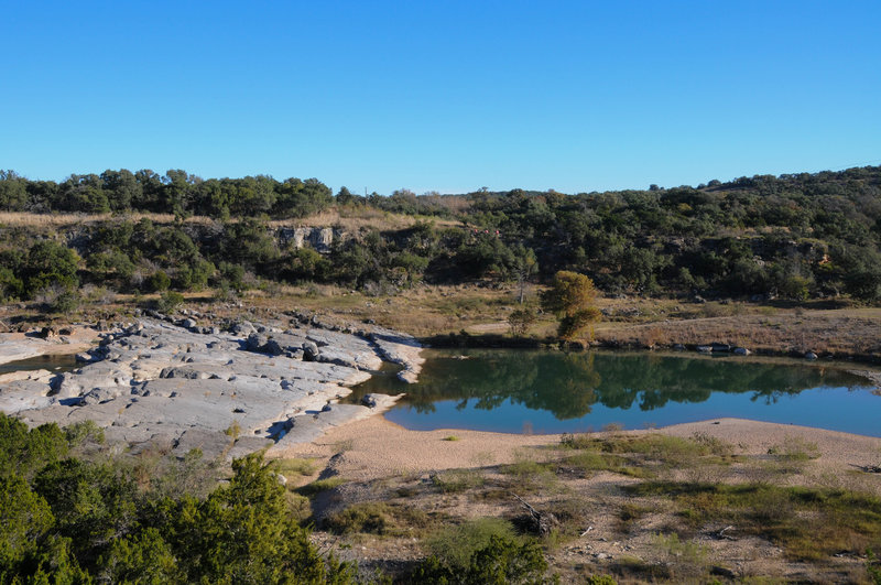 Reflections in the pools formed around the limestone slabs of Pedernales Falls