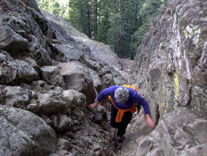 Climbing above the chockstone during a scramble to the summit