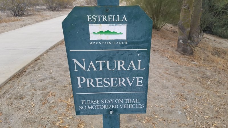 Sign at main walkway entering the trail from the street.
