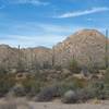Views of Saguaro cacti and the surrounding hills are all around you.