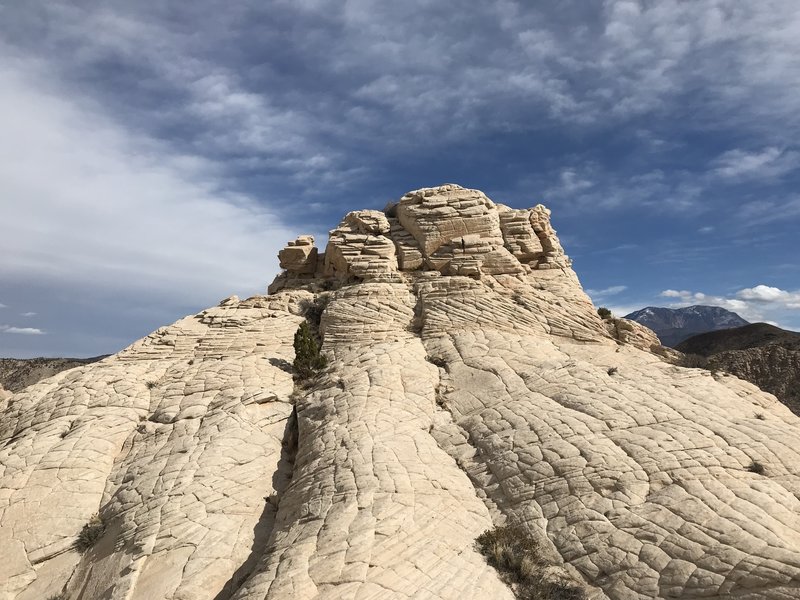 From the lower peak, facing the "pimple" dome".  Once on top, you'll find other adventurers have been thoughtful enough to scratch their names into the sandstone - don't be that type of idiot.