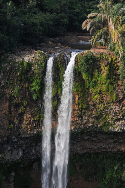 Chamarel Falls plunging over a cliff covered in lush vegetation.