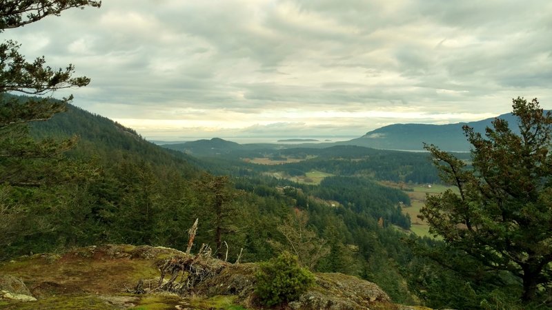 Orcas Island farm lands, Sucia and little Matia Islands, and Canada (center, near to far) and north shoulder of Mt. Constitution rises behind East Sound on the right, looking northeast from Ship Peak.
