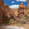 A rock formation that resembles a watchman at the end of a wetter section in Wolverine Canyon