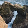 Watch the waves break through a rock arch formation at the end of Chimney Rock trail.