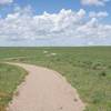 You can see the trail meandering through the high plains. You'll notice there is no shade, so make sure to bring plenty of water, apply sunscreen, and wear a hat.