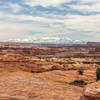 Snow covered La Sal Mountains across the canyons in the Needles District