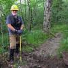 Volunteer trail maintainer builds steps on the trail leading to Bob Bald