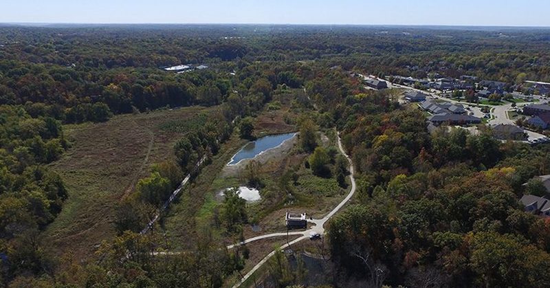 Drone footage, looking due west.  M-K-T trail to the left of photo, loop trail and Forum Connector to the center right.