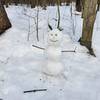 A snowman guarding the fork in the trail.