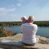 Dad and baby on a bench overlooking the St. Lawrence River