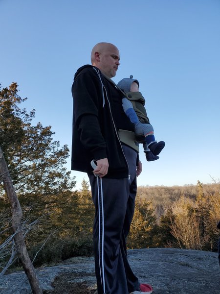 Man and baby atop lookout rock