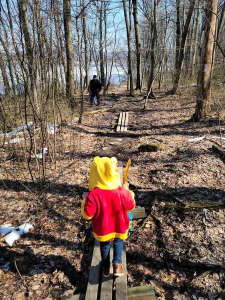 Five-year-old hiking along a bridge on the Deer Path Trail.