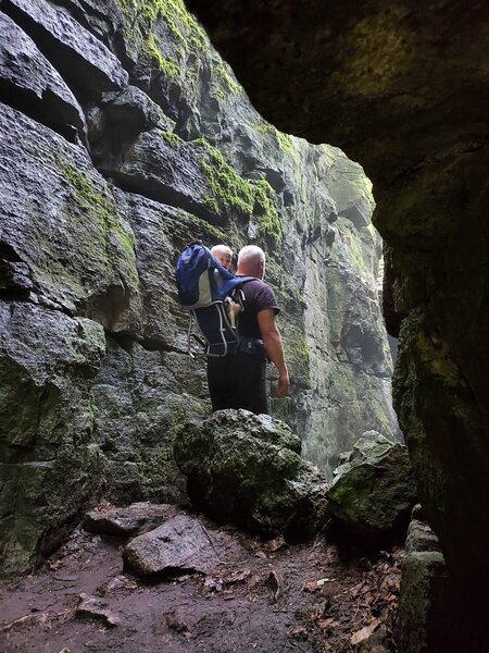 Man and baby in a cave.