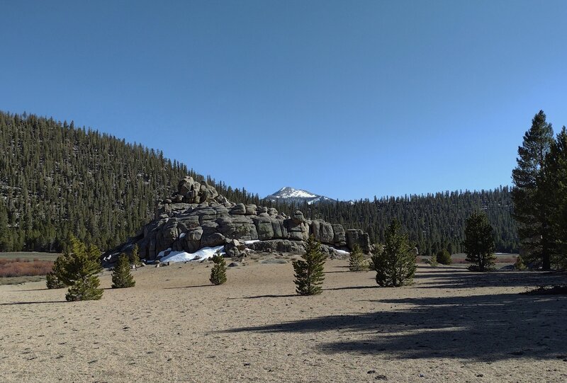 Kern Peak, 11,510 ft. (distant center), is seen to the south from Trail Pass Trail. Nearby in Tunnel Meadow, is an interesting rock pile, one of many that dot the landscape.