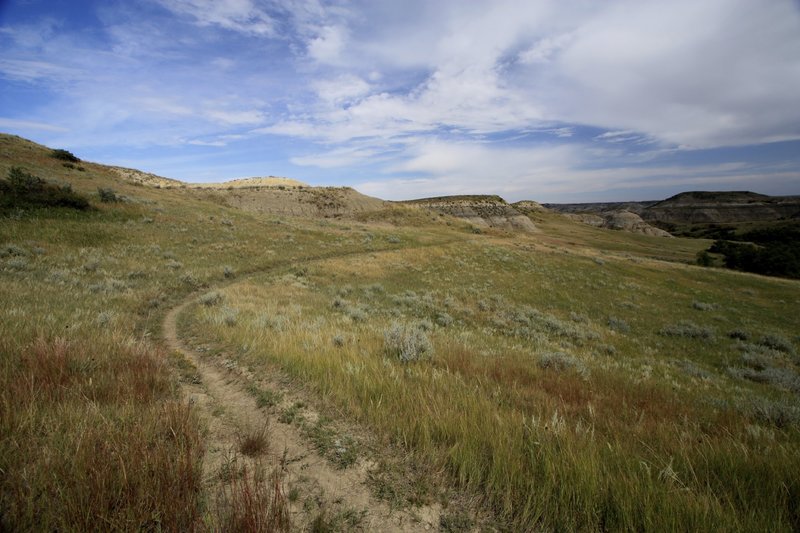Epic singletrack of the Maah Daah Hey trail winding through the painted hills of the badlands.