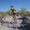 Alex riding the creek bed section at the top of loop 3.