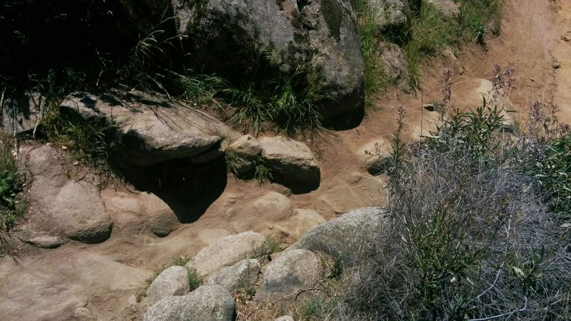 Technical area on the Granite Bay Trail featuring large rocks and loose dirt.