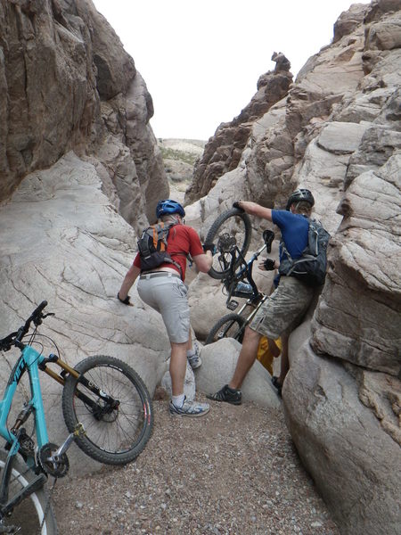 Passing bikes down the granite slot canyon. It helps to have a friend!