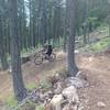Couple of youngsters flying through the bermed corners inf the new upper section of the trail