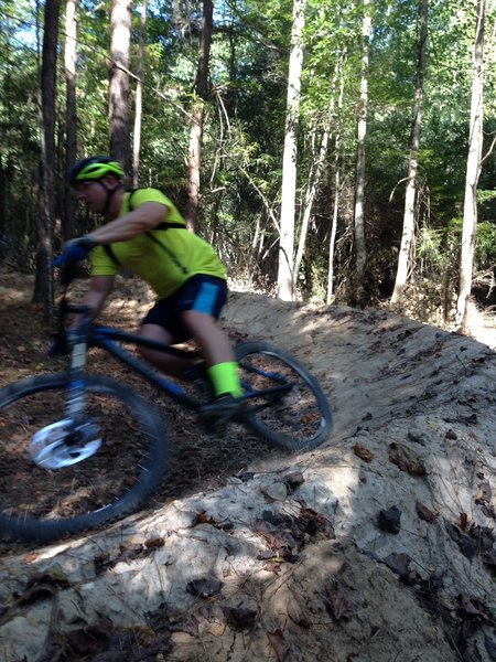 Steve, a near by law officer, "SPEEDS" around the new berm. This is fun addition to a fast and technical downhill section.
