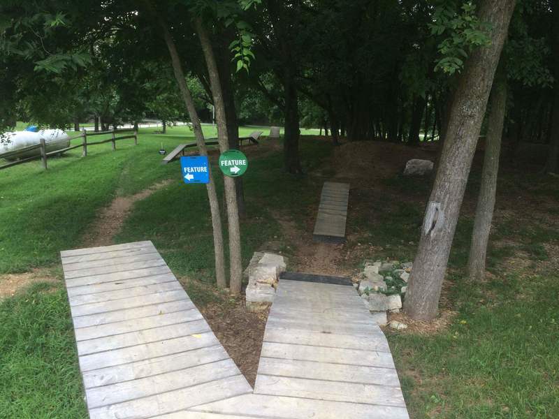 Many features are available at Two Rivers Mountain Bike Park. If you take the ramp down to the right, you go through some berms; take the left side for about a 2' drop then the choice of another small drop (about 18") or a larger drop (approx. 3').