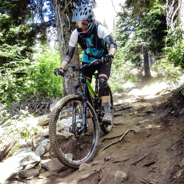 Julie  navigating the rock gardens at the top of 140.