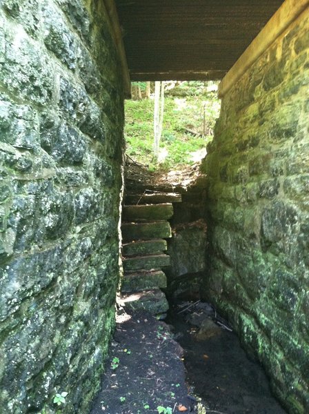 Near mile 18 there is a hidden support bridge. Here's a stone stairwell and corridor that runs beneath the trail.
