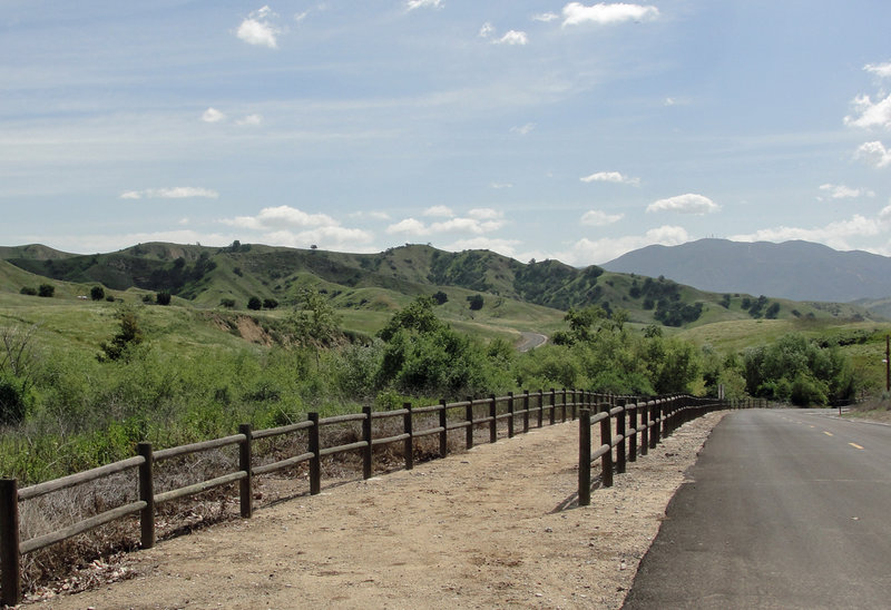 Stay left, and prepare for a hard-left, across the bridge, just before the bottom of the hill.