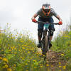 Eric Dukes flies past spring blooms on Thrillium during the Cascadia Dirt Cup.