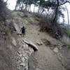 Traversing one of the slides that can happen on this trail after heavy rains.