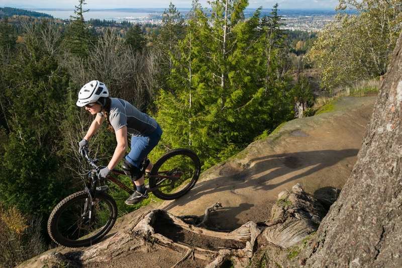Emily rides the edge on the Ridge Trail, Galbraith Mountain, WA.