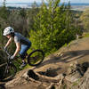 Emily rides the edge on the Ridge Trail, Galbraith Mountain, WA.