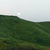 A full moon climbs above the ridgeline along the South Ridge Trail.