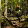 Riders navigate some of the rock slabs found near the bottom of the Wales trail.