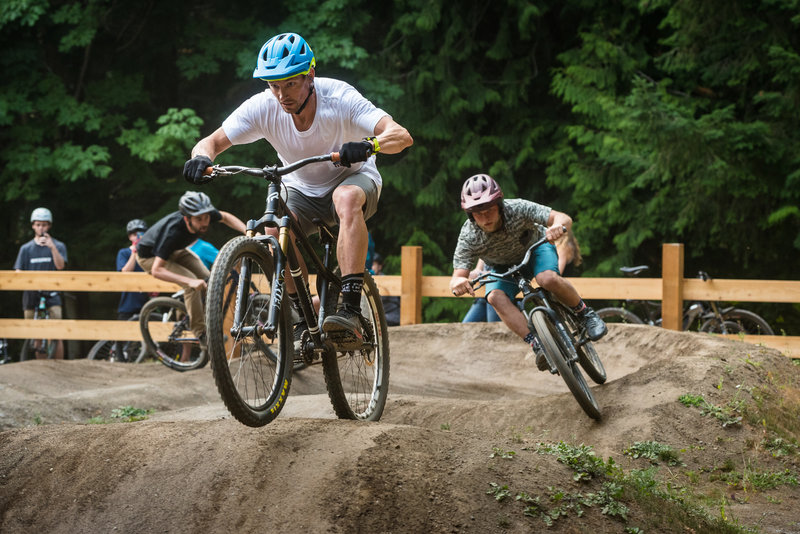 Lars Sternberg and Kelend Hawks ride a train around the newly opened pumptrack.