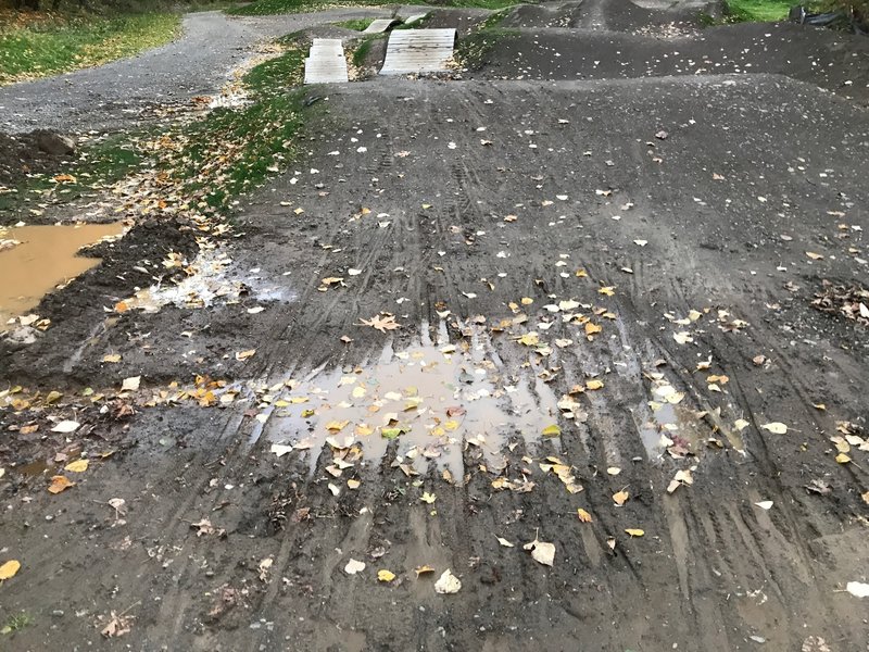 Puddle and rutting on the drop in to the Skills area of Gateway Green; CLOSED until further notice.