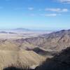 The flat area right after the mountain range is where you are heading.