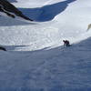 A skier carves down Breakfast Couloir.