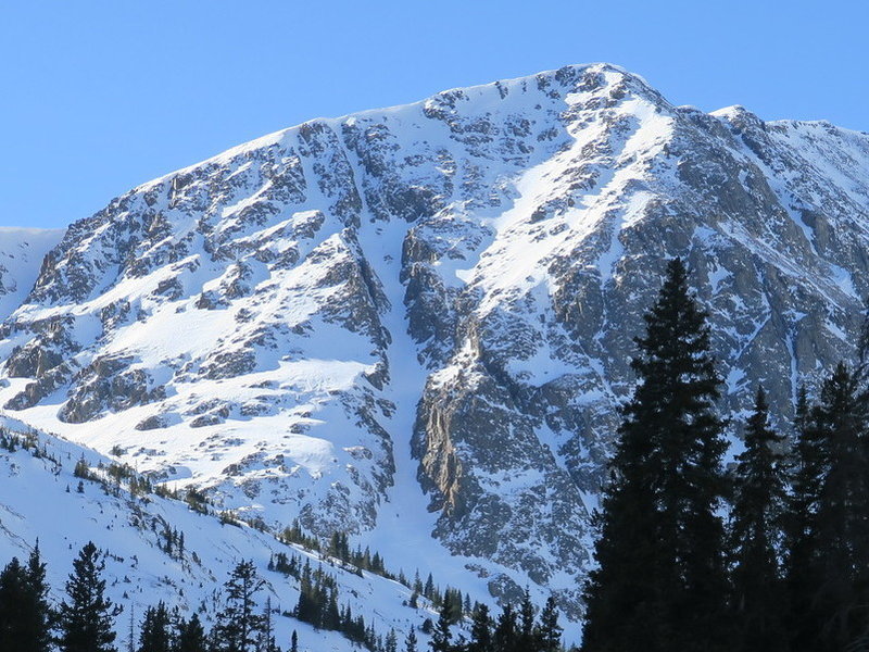 Grizzly Couloir, with a snowboarder exiting the bottom.